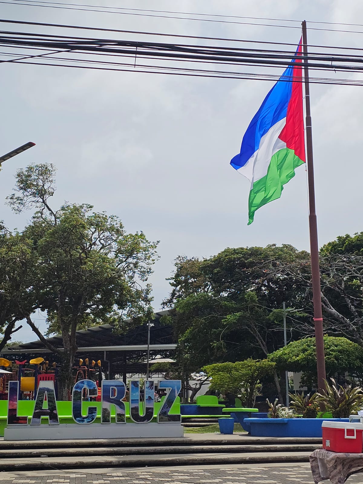 Letras LA CRUZ y bandera del cantón en la plaza